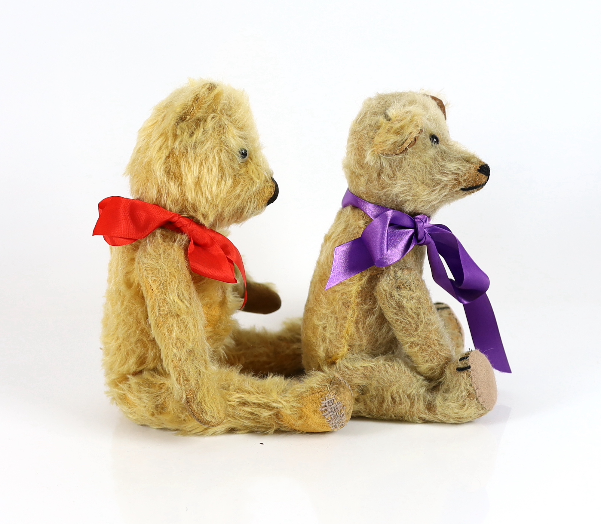 A plush covered bear with purple ribbon, 30cm and a plush covered bear with tartan ribbon, 36cm (2)